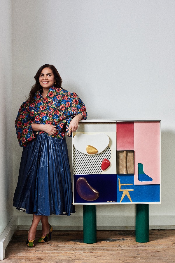 woman standing next to art work
