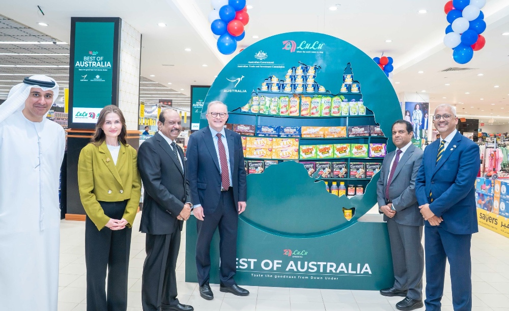 men and women stand in a supermarket