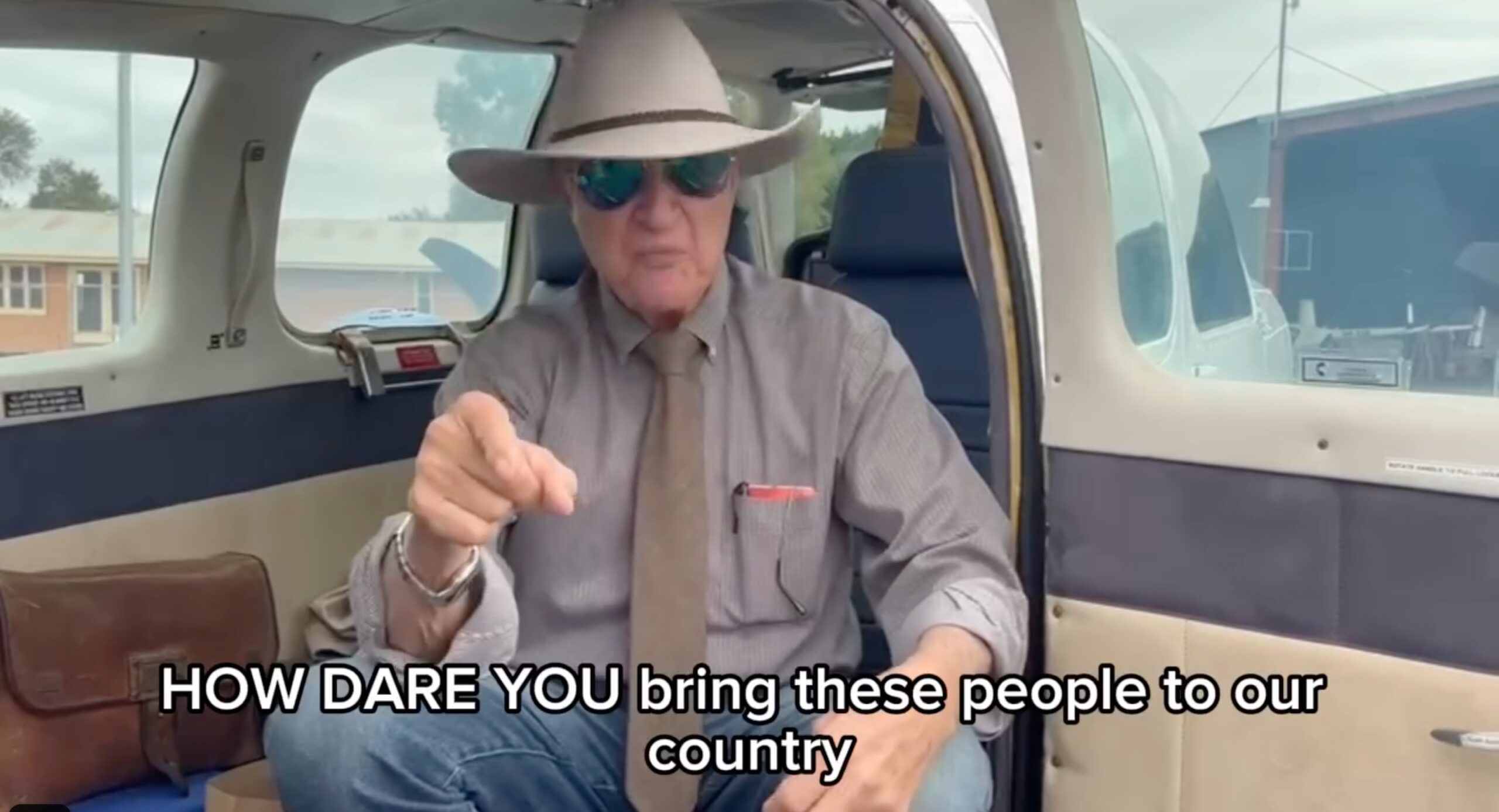 Man in hat sitting in a car 