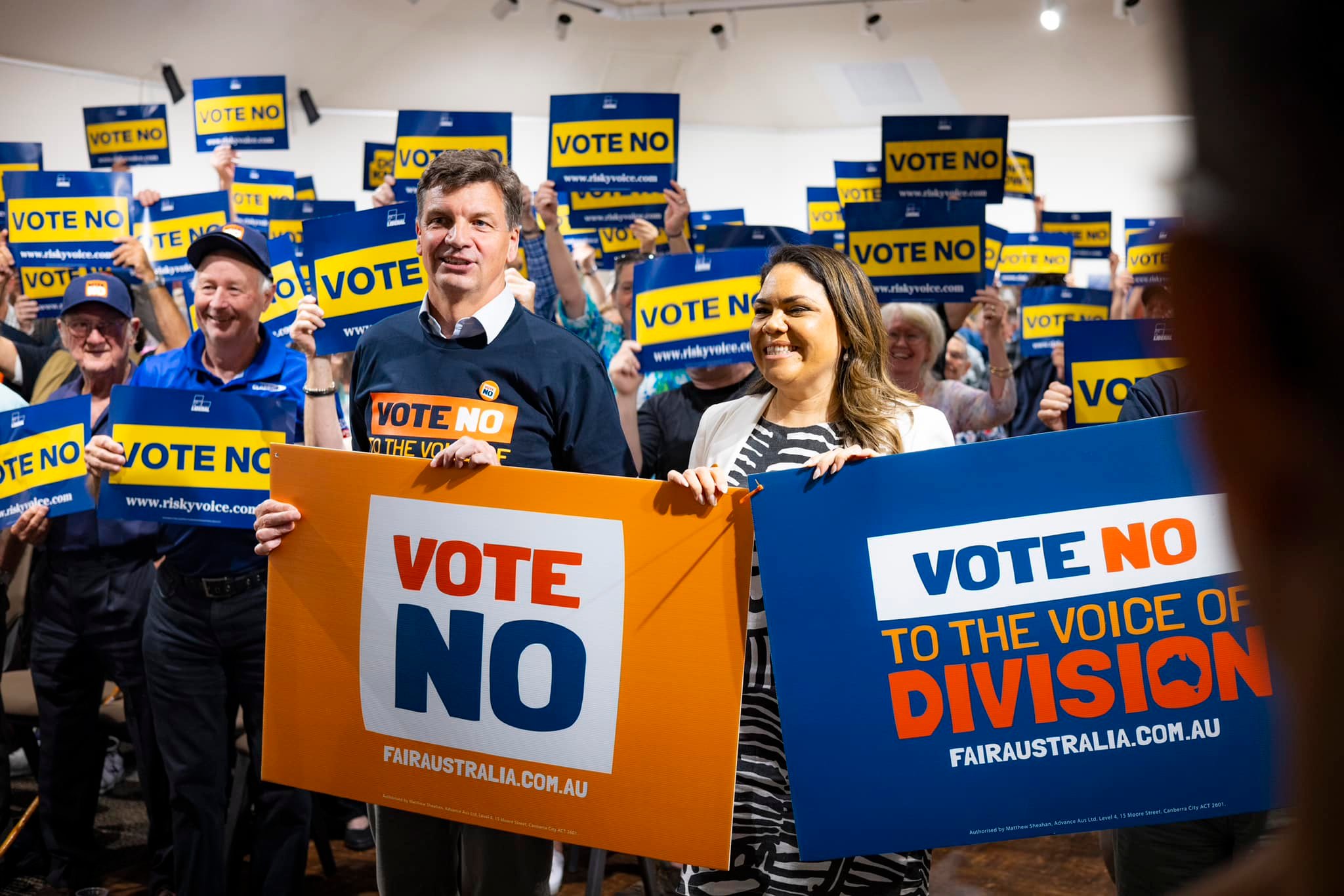 men and women holding posters that say Vote No