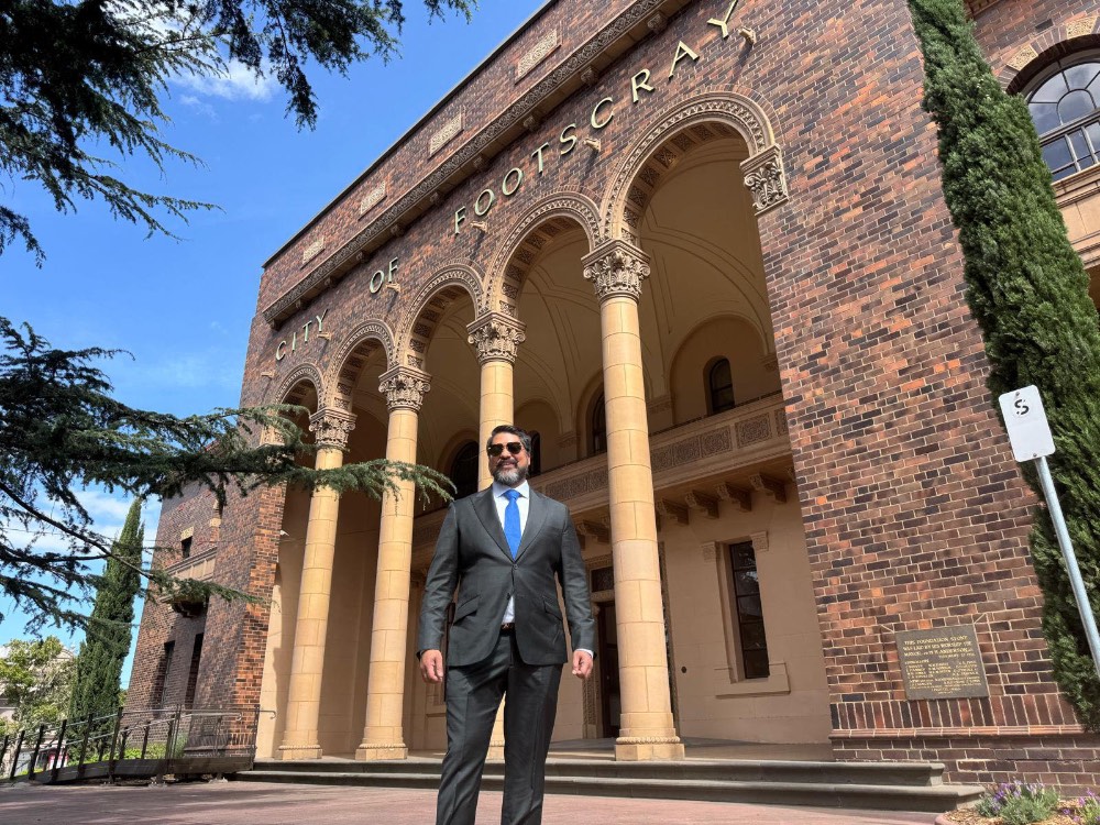 man in suit standing in front of a building