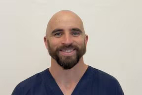a man with shaved head and a beard