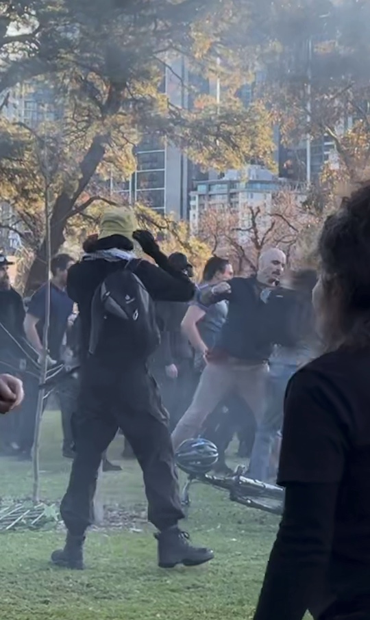 men in black attacking people