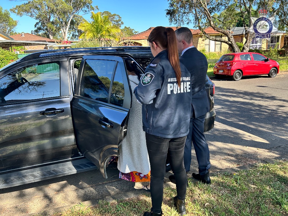 male and female officer with a female accused