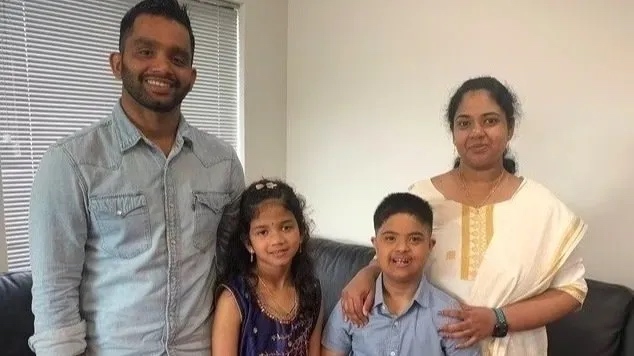 man and woman with boy and girl