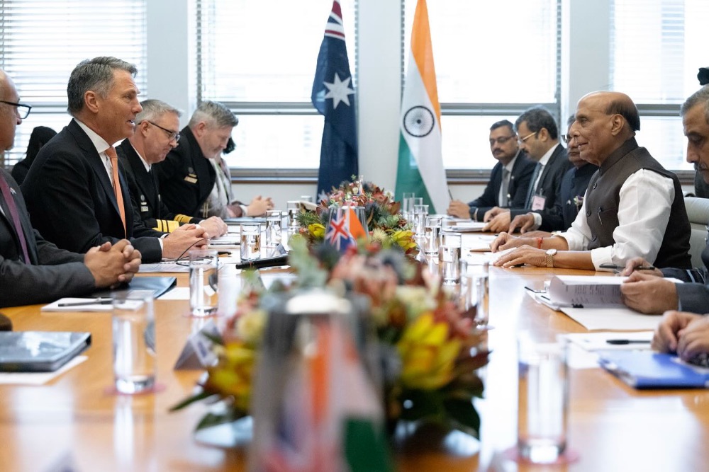men sitting on a table in a meeting