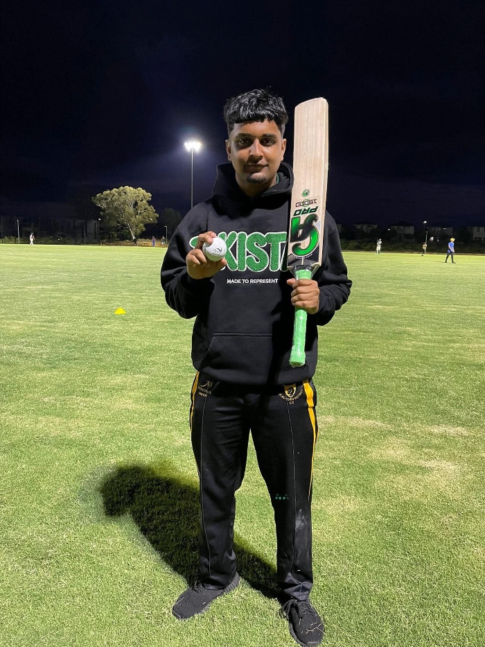 man with cricket bat and ball