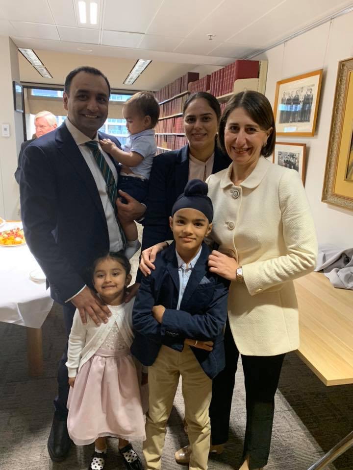 a man and two women posing with three children