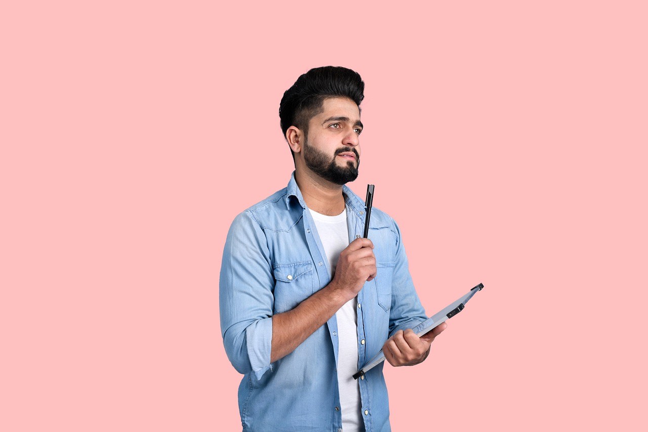 man with pen and pad