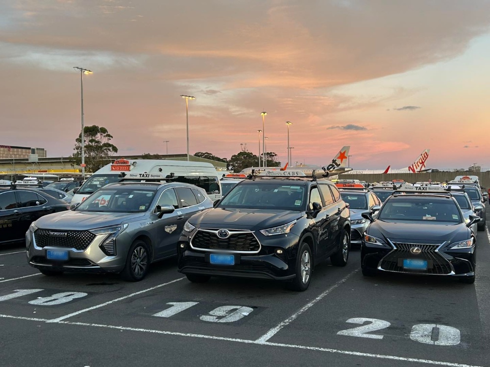 Taxis lines up and planes in the background