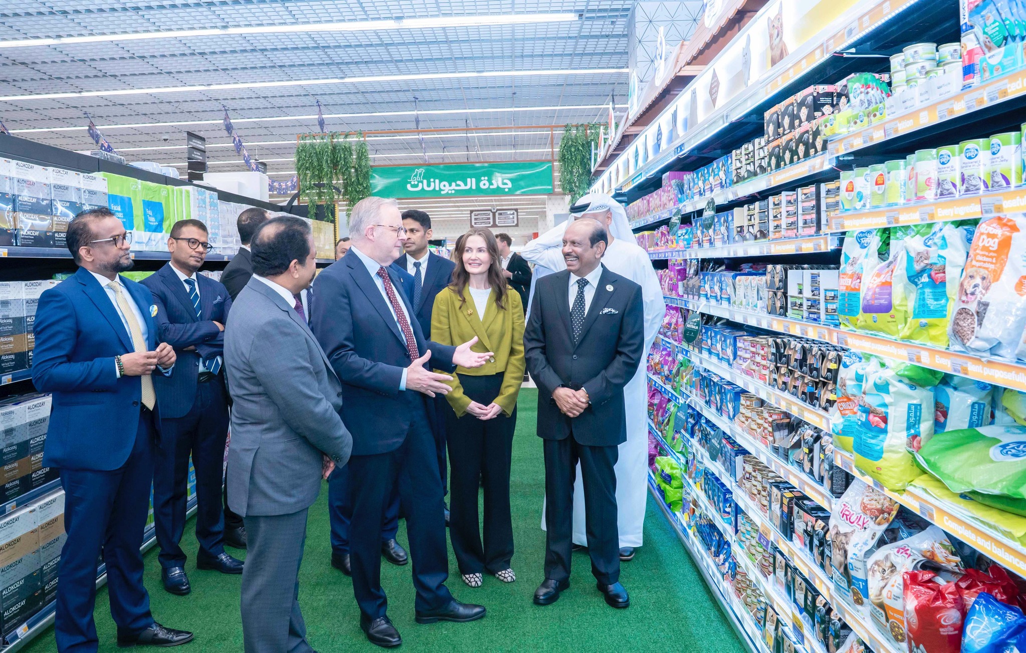 men and women stand in a supermarket
